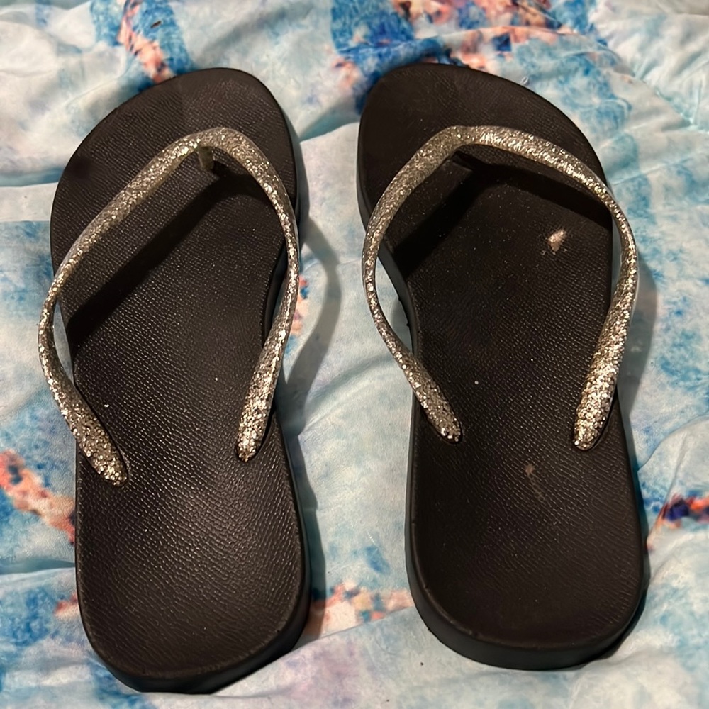 Black sparkly flip flops